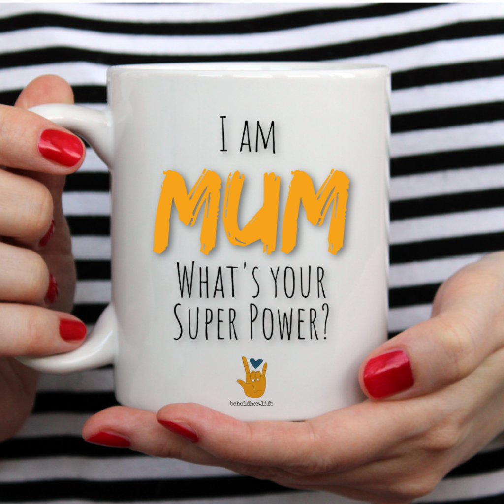 beholdher.life blog no 7 the mother guilt effect i am a mum what's your super power mug held by woman with red nails and black and white striped shirt